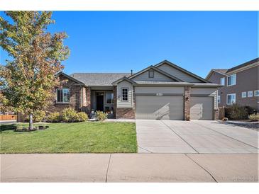 Brick ranch home with 2-car garage, landscaped lawn, and inviting curb appeal at 2640 Cache Creek Ct, Castle Rock, CO 80108