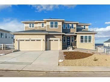 Modern two-story home with a three-car garage and a landscaped front yard at 5075 Hickory Oaks St, Castle Rock, CO 80104