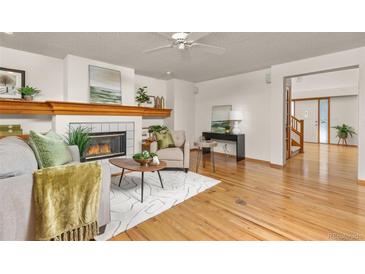 Living Room with hardwood floors, fireplace and view to the entryway at 5123 Red Oak Way, Parker, CO 80134