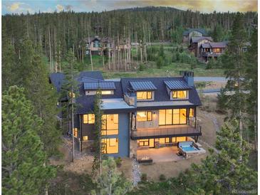 Luxury home with mountain views, deck, and hot tub; multiple levels and large windows at 245 Fairways Dr, Breckenridge, CO 80424