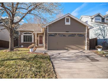 Charming ranch-style home with a two-car garage and well-manicured lawn at 7081 Palisade Dr, Highlands Ranch, CO 80130