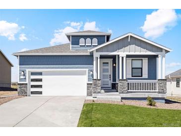 Craftsman style home with gray siding and white trim at 42996 Colonial Trl, Elizabeth, CO 80107