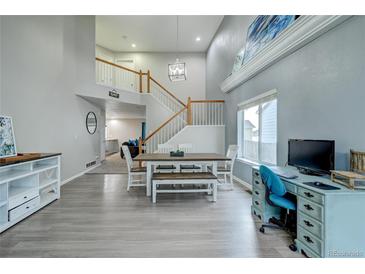 Bright dining area with hardwood floors and large windows at 5724 S Bahama W Cir, Aurora, CO 80015