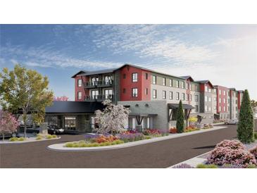 Attractive three-story building with inviting landscaping and ample parking at 12983 W Ida Ave # 306, Littleton, CO 80127