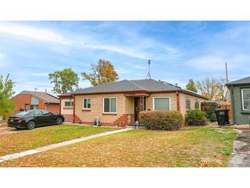 Brick ranch home with a well-manicured lawn at 2862 N Monroe St, Denver, CO 80205