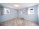 Light blue bedroom with carpet, window, and mirrored closet at 1448 W 102Nd Ave, Northglenn, CO 80260