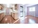 Kitchen with light wood cabinets, and a view into the dining and living areas at 1448 W 102Nd Ave, Northglenn, CO 80260