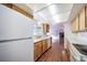 Kitchen with light wood cabinets, and a view into other rooms at 1448 W 102Nd Ave, Northglenn, CO 80260