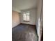 Simple carpeted bedroom with a window offering natural light at 3617 S Fundy Way, Aurora, CO 80013