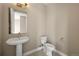 Small bathroom with pedestal sink and toilet at 3425 W 16Th Ave, Denver, CO 80204