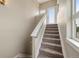 Modern carpeted staircase with white railings and a bright landing at 3425 W 16Th Ave, Denver, CO 80204
