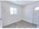 Clean bedroom featuring grey flooring and an exterior door at 991 E 88Th Ave, Thornton, CO 80229