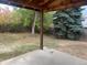 View from covered patio, showing fenced backyard and trees at 4394 S Ceylon Way, Aurora, CO 80015