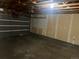 Unfinished garage with overhead door and pegboard at 4394 S Ceylon Way, Aurora, CO 80015