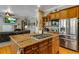 Bright kitchen boasts an island with cooktop and stainless steel appliances at 10364 Carriage Club Dr, Lone Tree, CO 80124