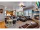 Spacious living room featuring a fireplace, large sectional sofa, and hardwood floors at 10364 Carriage Club Dr, Lone Tree, CO 80124