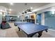 Finished basement with game tables, wet bar, and ample space for entertainment at 10364 Carriage Club Dr, Lone Tree, CO 80124