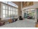 Spacious living room with large windows, vaulted ceilings, and a view into the dining area at 10364 Carriage Club Dr, Lone Tree, CO 80124
