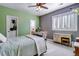 Bright bedroom with a green accent wall and built-in dresser at 10364 Carriage Club Dr, Lone Tree, CO 80124