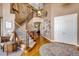 Grand two-story entryway with a curved staircase, hardwood floors, and high ceilings at 10364 Carriage Club Dr, Lone Tree, CO 80124