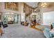 Bright and airy living room with hardwood floors, high ceilings, and a view of the staircase at 10364 Carriage Club Dr, Lone Tree, CO 80124