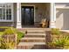 Inviting front porch with brick steps, landscaping, and a charming wooden bench at 10364 Carriage Club Dr, Lone Tree, CO 80124