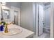 Bathroom with a white vanity, gold fixtures, and shower/tub combo at 10364 Carriage Club Dr, Lone Tree, CO 80124