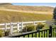 Landscaped backyard with a white fence and open space views at 10364 Carriage Club Dr, Lone Tree, CO 80124