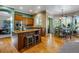 Modern kitchen with wood cabinetry, island, breakfast nook and hardwood floors at 10364 Carriage Club Dr, Lone Tree, CO 80124