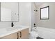 Modern bathroom with a shower/tub combo and vanity at 1828 S Williams St, Denver, CO 80210