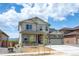 Two-story house with light beige siding, stone accents, and a two-car garage at 1815 Chaffee Crest Dr, Berthoud, CO 80513
