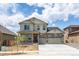 Two-story house with light beige siding, stone accents, and a two-car garage at 1815 Chaffee Crest Dr, Berthoud, CO 80513