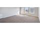 Spacious bedroom with neutral carpeting and multiple windows at 1815 Chaffee Crest Dr, Berthoud, CO 80513