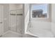 Bathroom with shower, bathtub, and window at 1815 Chaffee Crest Dr, Berthoud, CO 80513