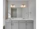 Double vanity bathroom with a large mirror and modern fixtures at 1815 Chaffee Crest Dr, Berthoud, CO 80513