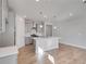 Bright kitchen featuring an island and hardwood floors at 1815 Chaffee Crest Dr, Berthoud, CO 80513