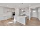 Modern kitchen with island, stainless steel appliances, and light gray cabinets at 1815 Chaffee Crest Dr, Berthoud, CO 80513