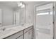 Bathroom with double vanity and a separate tub and toilet area at 1815 Chaffee Crest Dr, Berthoud, CO 80513