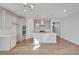 Open kitchen with island, double oven, and hardwood floors at 1815 Chaffee Crest Dr, Berthoud, CO 80513