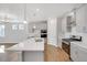Modern kitchen with island, stainless steel appliances, and hardwood floors at 1815 Chaffee Crest Dr, Berthoud, CO 80513