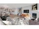 Open concept living room with a fireplace, hardwood floors, and large windows at 1815 Chaffee Crest Dr, Berthoud, CO 80513
