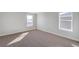 Bright bedroom with carpet flooring and two windows at 1815 Chaffee Crest Dr, Berthoud, CO 80513