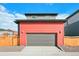 Two-story home with gray and coral exterior and wooden fence at 21124 E 63Rd Dr, Aurora, CO 80019