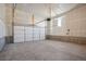 Unfinished garage with overhead door and ample space at 21124 E 63Rd Dr, Aurora, CO 80019