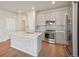 Modern kitchen with stainless steel appliances and an island at 21124 E 63Rd Dr, Aurora, CO 80019