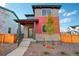 Modern two-story home with a mix of stone and red siding at 21124 E 63Rd Dr, Aurora, CO 80019