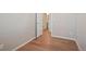 Simple bedroom with hardwood floors and door to bathroom at 21124 E 63Rd Dr, Aurora, CO 80019