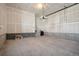 Unfinished garage with overhead door and interior access at 21124 E 63Rd Dr, Aurora, CO 80019