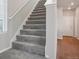 Gray carpeted staircase leading to the second floor at 21124 E 63Rd Dr, Aurora, CO 80019