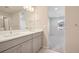 Modern bathroom with double vanity and view into bedroom at 21124 E 63Rd Dr, Aurora, CO 80019